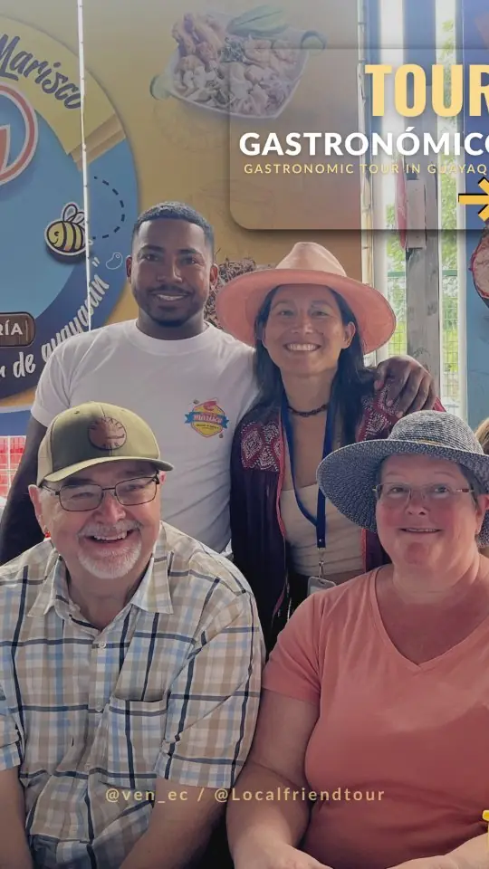 Travellers smiling together in front of a Guayaquil gastronomic tour sign